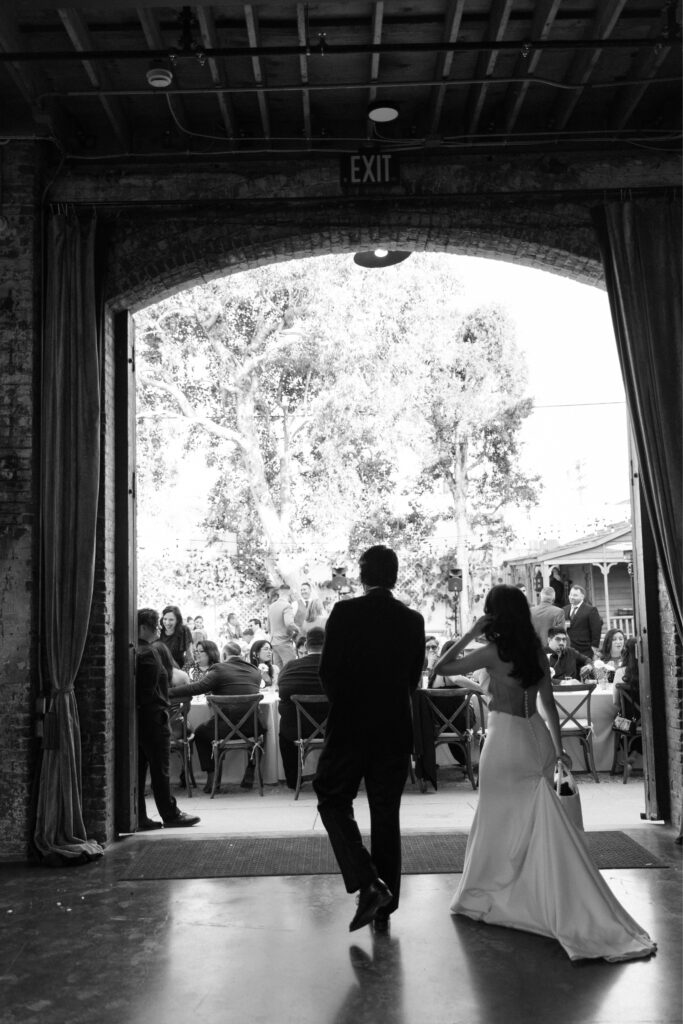 Newlyweds entering their wedding reception