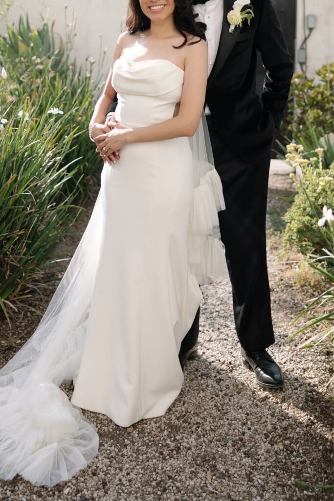 Newlyweds celebrating outside their wedding venue.