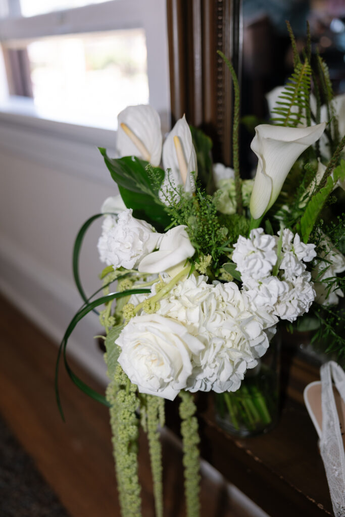 Bridal accessories including shoes, jewelry, and bouquet.