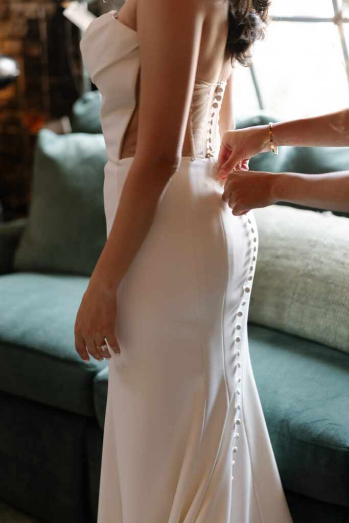 Bride getting ready in a vintage gown before her wedding.