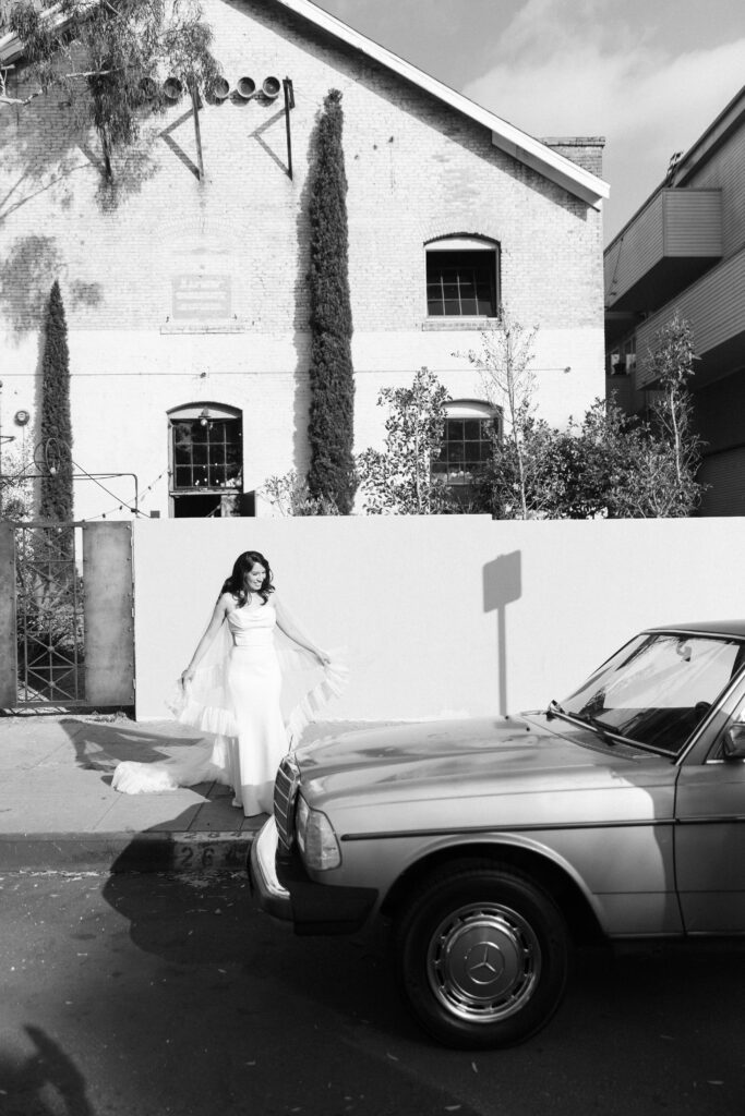 Romantic wedding portraits with a vintage getaway car.