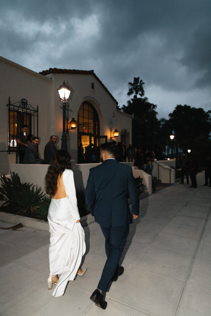 Joyful wedding day exit surrounded by family and friends.
